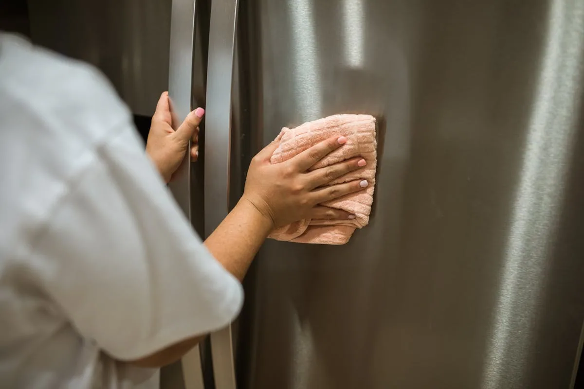 A refrigerator being maintained - the kind of appliance where the 'fix' isn't confirmed until a few days of runtime.