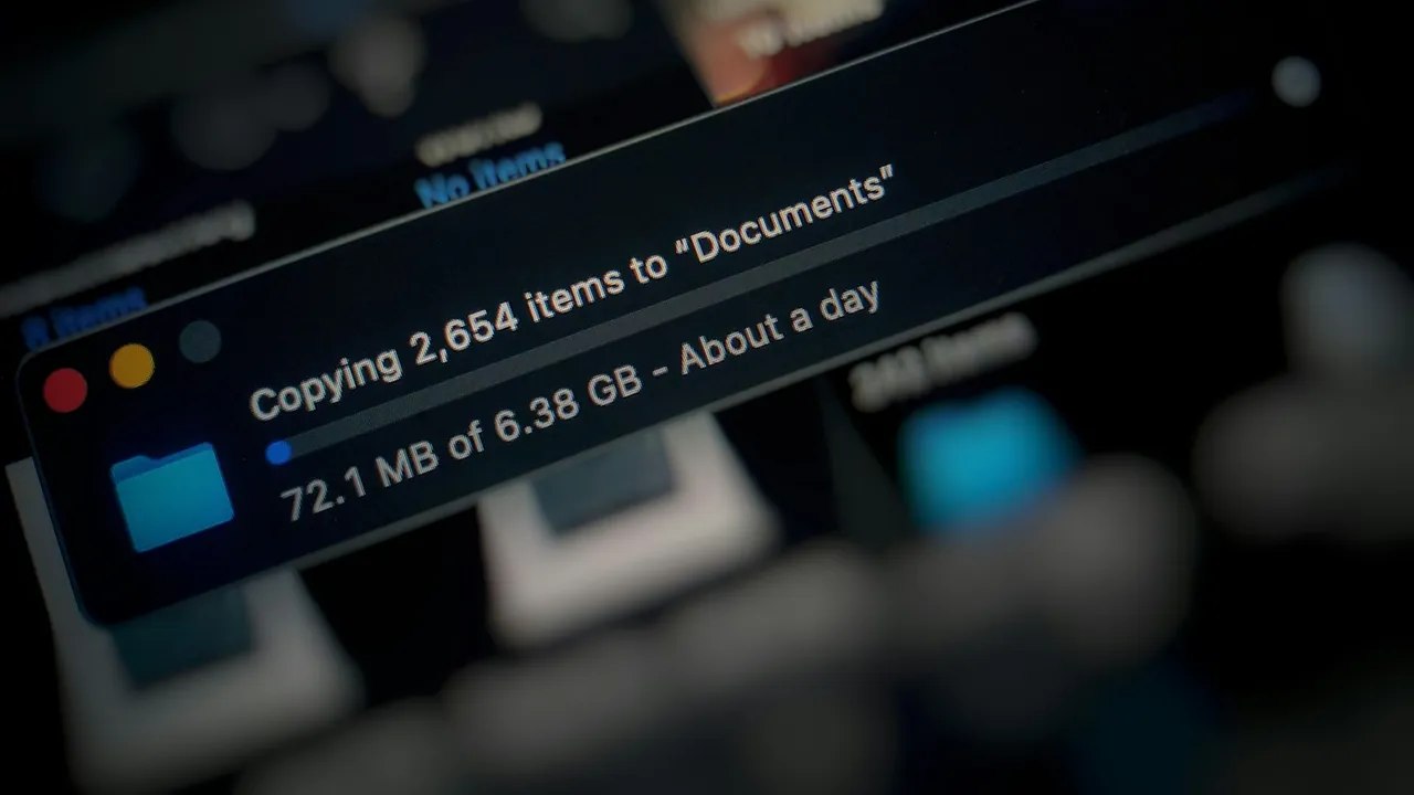 Laptop screen showing a file copy in progress, with 2,654 items being copied to a Documents folder.